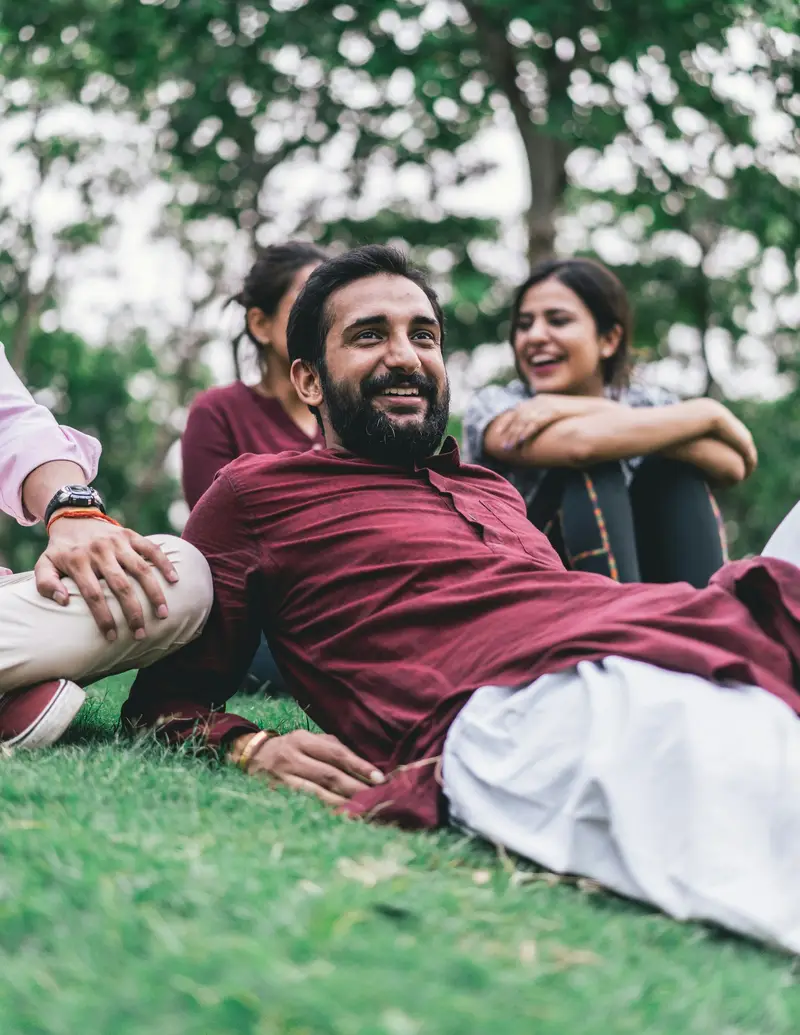 Friends laughing together on the grass